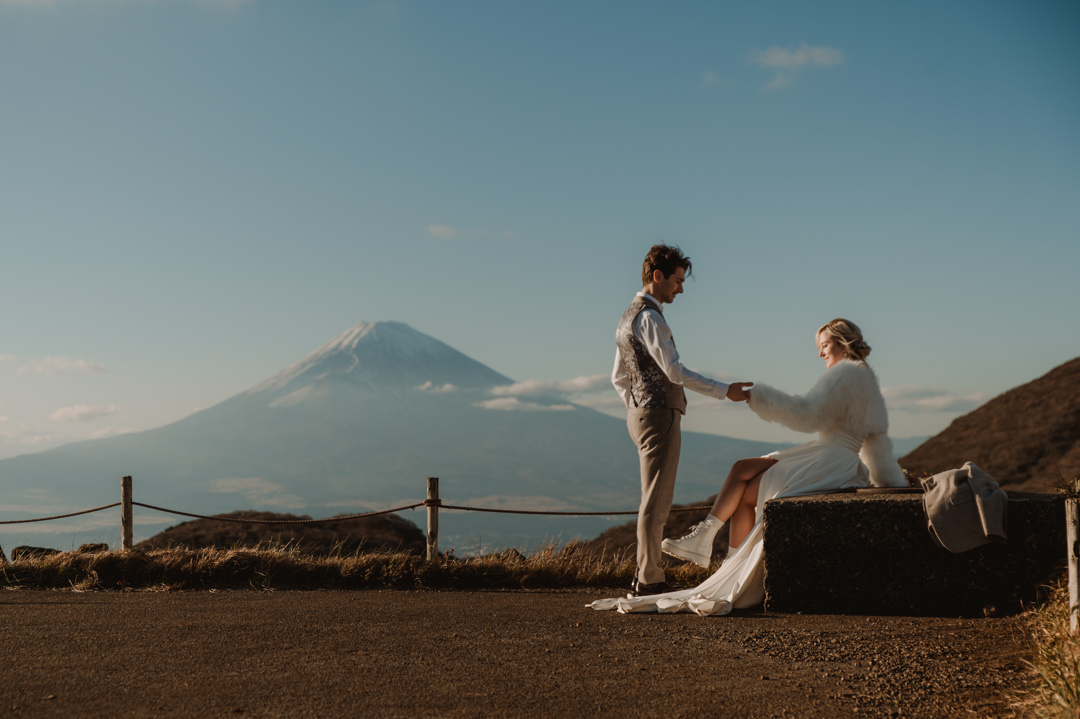Hakone Elopement - Groom is taking the bride's hand with Mt. Fuji backdrop