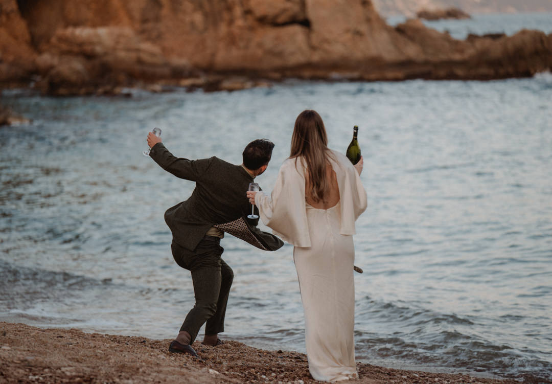 marimurtra elopement - couple playing on the beach