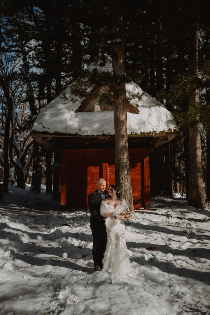 The couple has a photo shoot at the shrine. Nagano Snow Elopement