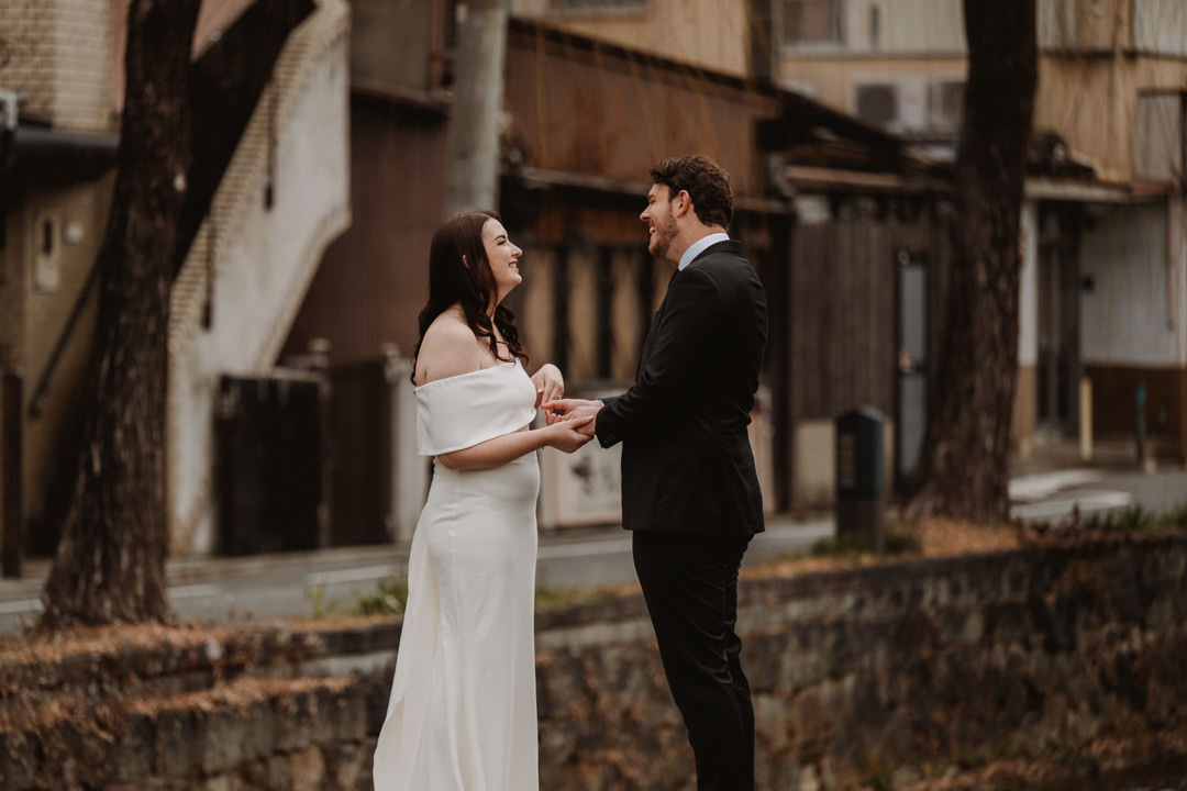 The couple has the ceremony on the bridge. Snow Shrine Elopement in Japan