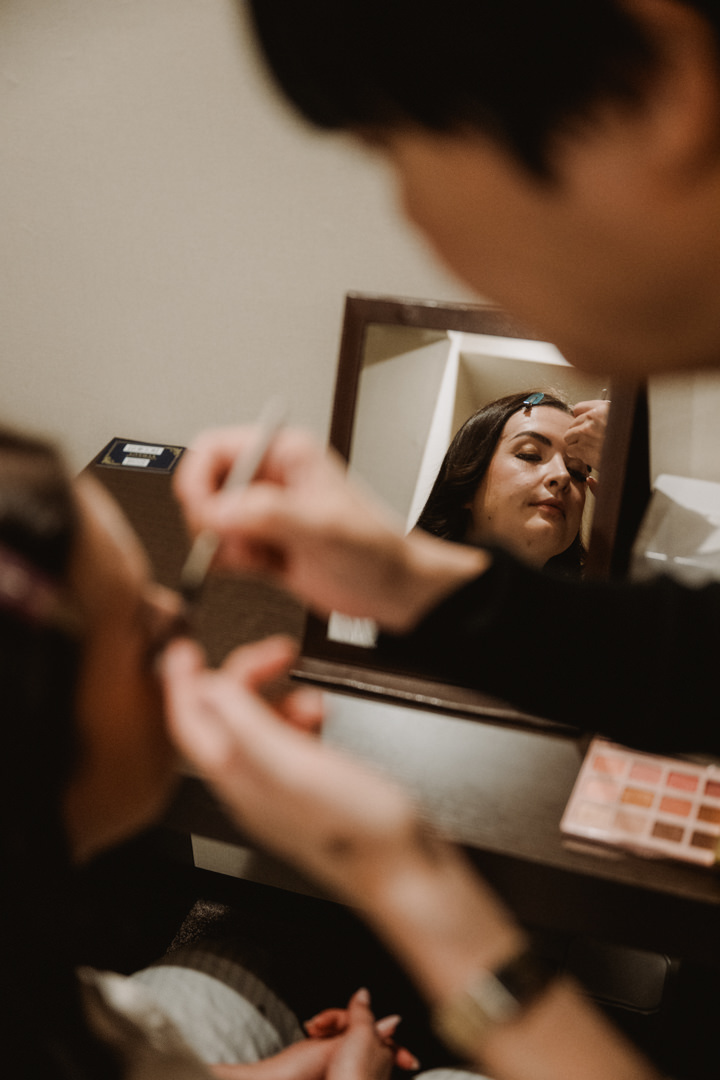 The bride gets ready at their hotel. Snow Shrine Elopement in Japan