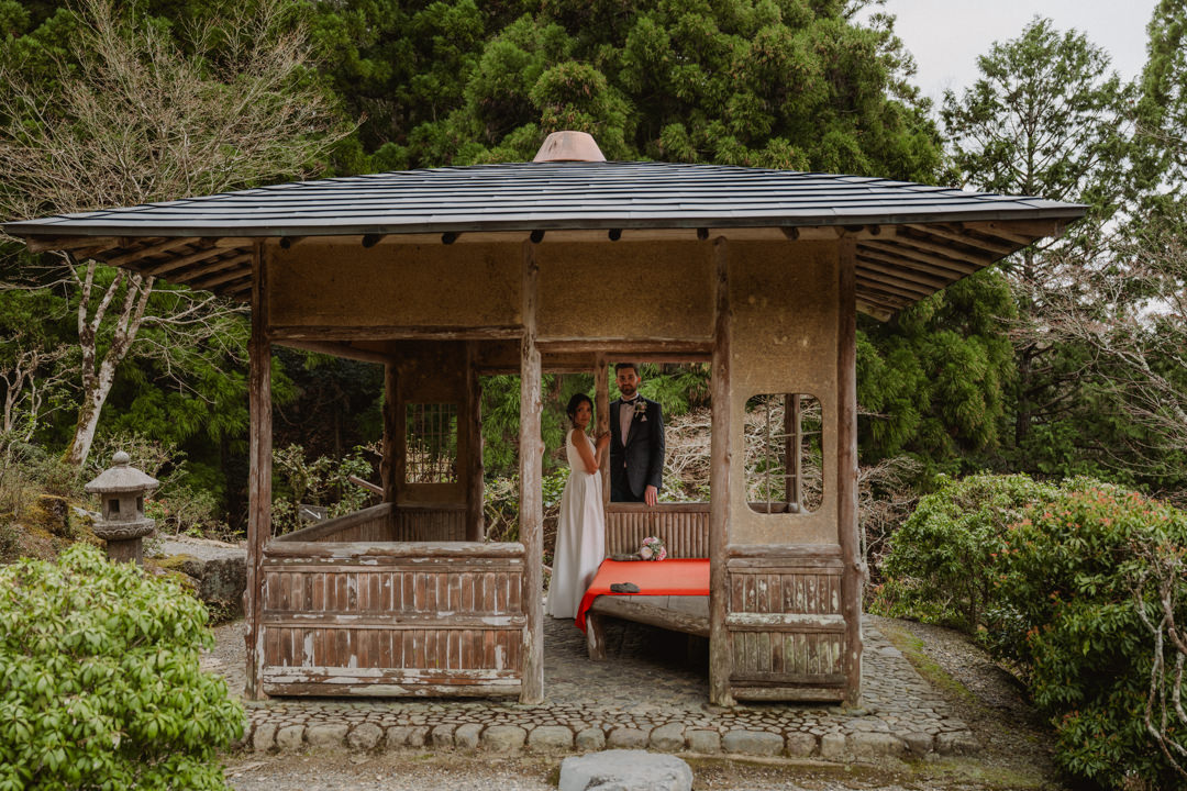 The couple takes a photo in a Japanese garden.  Private garden elopement in Kyoto 
