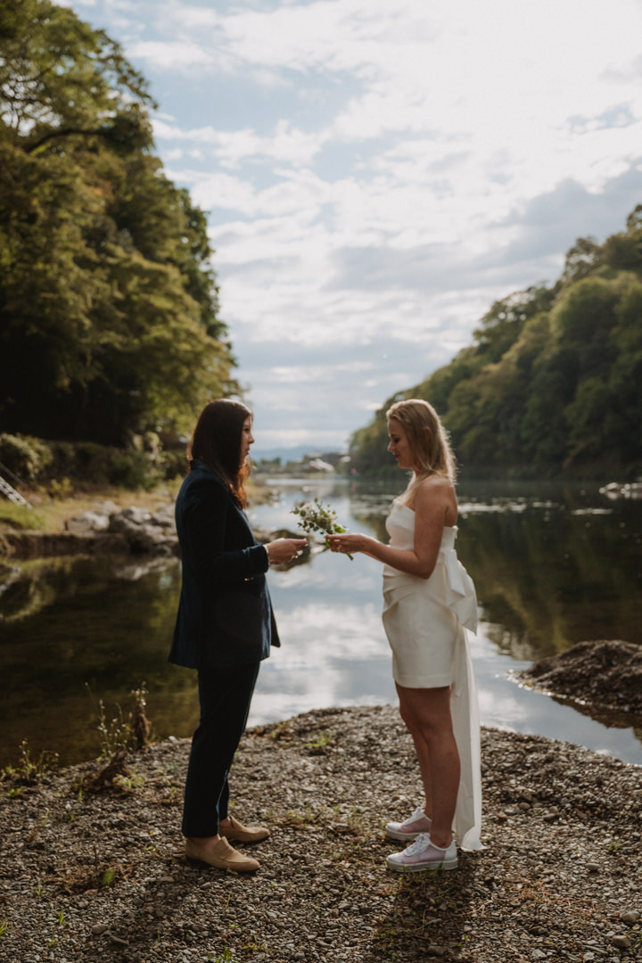 The couple exchanges their vows near the river, a same sex elopement in Japan.
