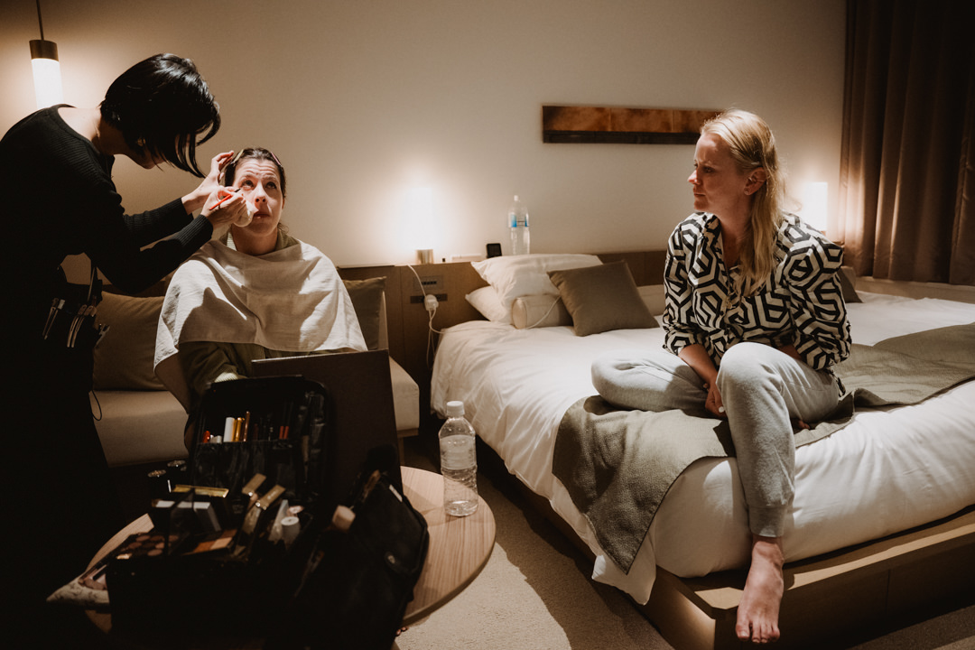 The couple gets ready in their hotel room, a same sex elopement in Japan.